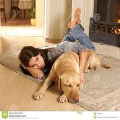 A Cute Brunette With A Dog On A Comfortable Carpet Royalty Free - Karbonix