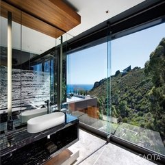 Above Black Table Near Glazed Wall With Outside View White Washbasin - Karbonix