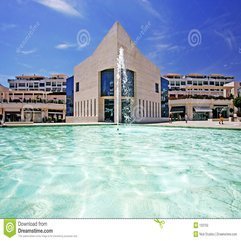Amazing Architecture Of Modern Building Next To Pond With Fountain - Karbonix