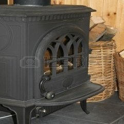 An Old Black Cast Iron Fireplace With Baskets Of Firewood Next - Karbonix