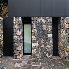 Door In Black Frame Placed Between Stone Wall Finishing Gazed - Karbonix