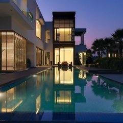 Home With Yellow Lighting Inside Viewed From Infinity Pool Two Levels - Karbonix