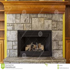 Natural Gas Insert Fireplace With Stone And Wood Stock Image - Karbonix
