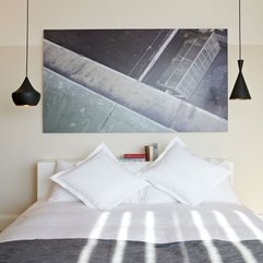 Pillows Placed Under Black Painting On White Wall White Bed - Karbonix