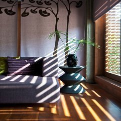 Plants In Black Pot On Small Table Near Purple Sofa In Green - Karbonix