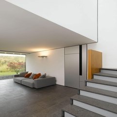 Sofa With Grey Orange Cushions Placed In Front Of White Wall Near Stairs Grey - Karbonix