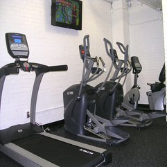 Treadmills Running With Flat Tv Patch In The White Exposed Brick Wall In Modern Style - Karbonix