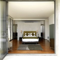 White Bed Between Black Table With White Orchid In Green - Karbonix