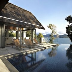 Woden Lounge Chairs Overlooking Ocean View Infinity Pool - Karbonix