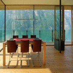 Wooden Table With Red Table Cloth Overlooking Outside View Through Glazed Wall Red Chairs - Karbonix